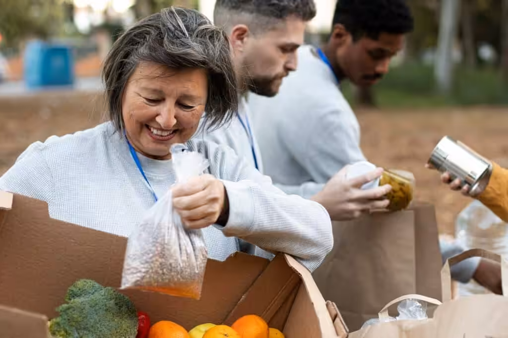 Volunteers packaging food donations outdoors