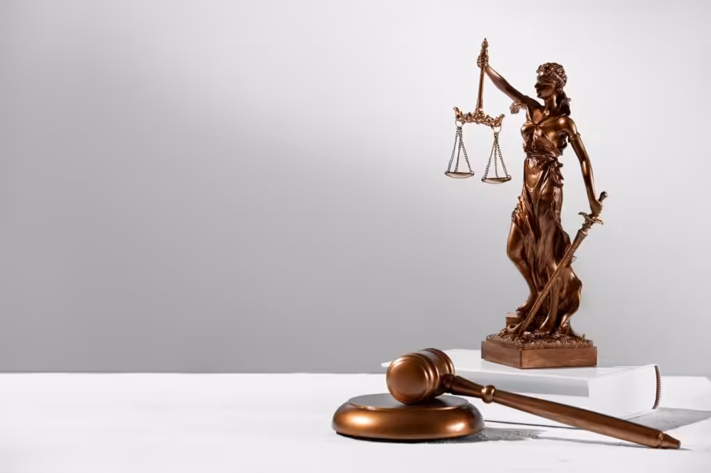 Bronze Lady Justice statue and gavel on desk